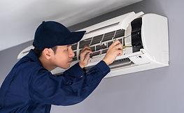 Technician Repairing Air Conditioner
