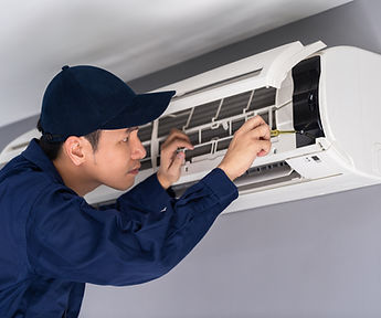 Technician Repairing Air Conditioner