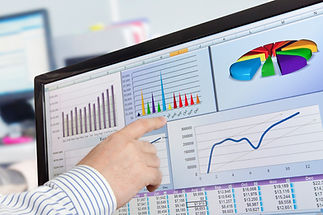 Corporate professional pointing directly to a colorful pie chart displayed on a monitor