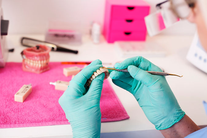 Dental technician working on a tooth crown