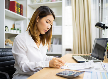 A woman checking documents on the desk