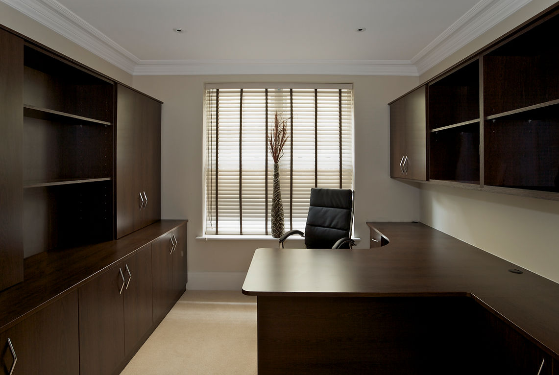 home office with shelves, table and chairs