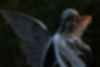 Low Angle View Of Angel Statue At Graveyard
