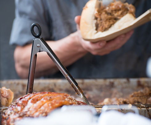 Man serving a hog roast sandwich