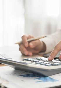 Professional reviewing tax documents with a calculator and pen