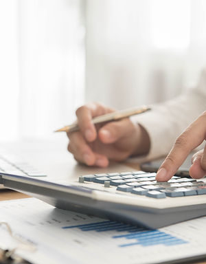 Businessman using a calculator to calculate the numbers