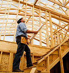 Construction worker reviewing building plans at construction site