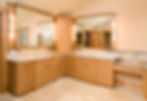 Beautiful bathroom with two sinks and vanity mirrors, wooden cabinets and tiled floor