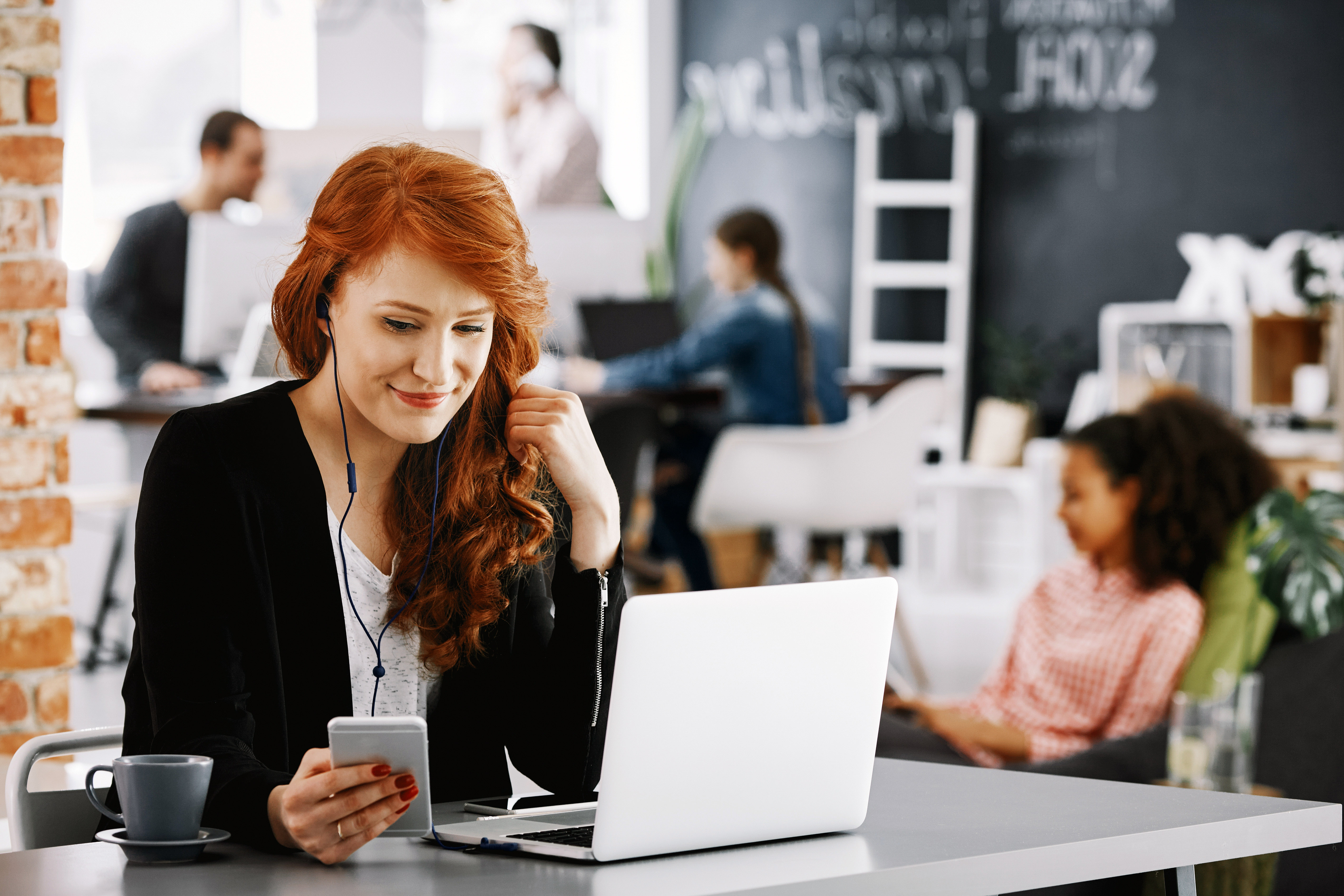 Multitasking woman managing business on computer and phone (credit: via Wix, Shutterstock, Unsplash).