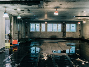 Empty basement under renovation with wet floor