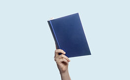 hand holding up a hardcover book