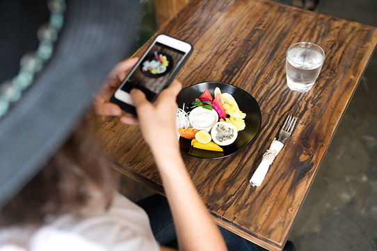 The person is taking a photo of her food, more likely she will gonna post it to her social media.
