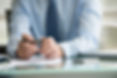 Accountant hands using a pen and calculator over financial documents in Beaconsfield