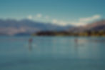 Two people paddleboarding on a lake in an iconic destination