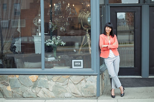 Portrait of female business owner standing outside furniture shop