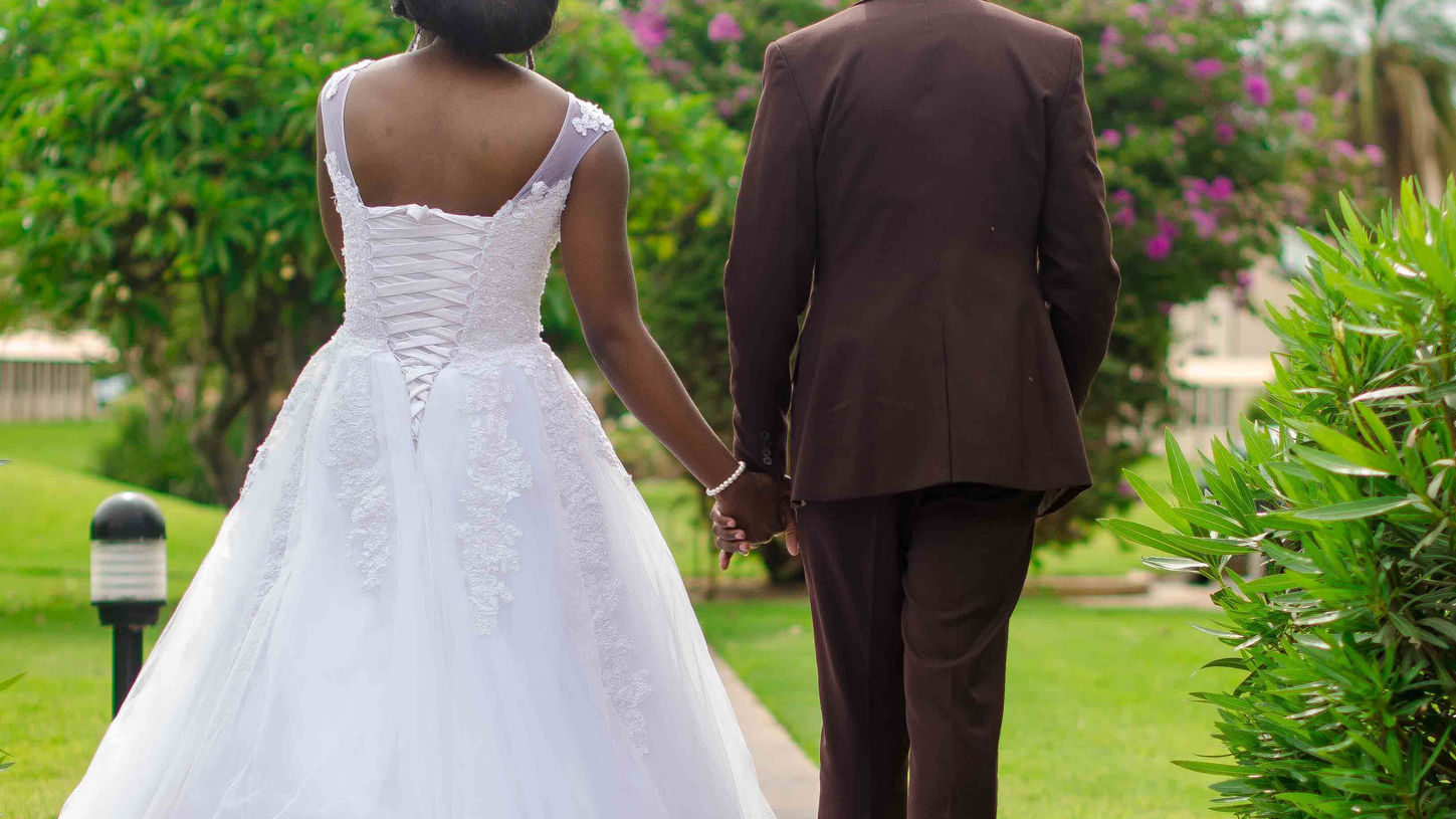 Couple holding hands walking away