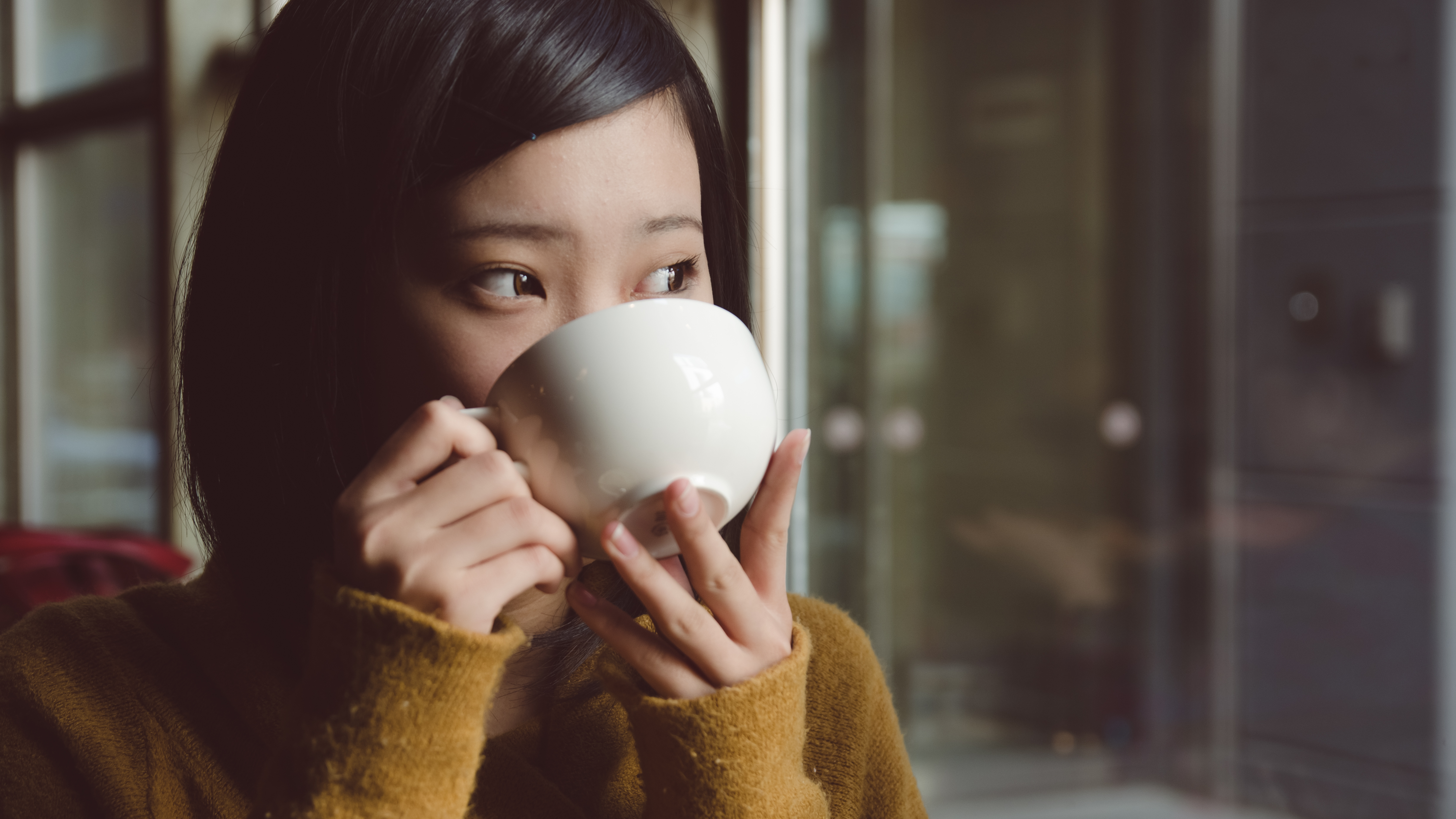 Asian woman drinking coffee
