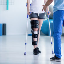 Prosthetic user practising walking with a physical therapist during rehabilitation