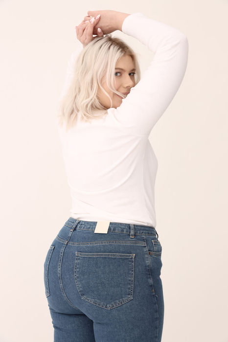 Woman in white top and jeans