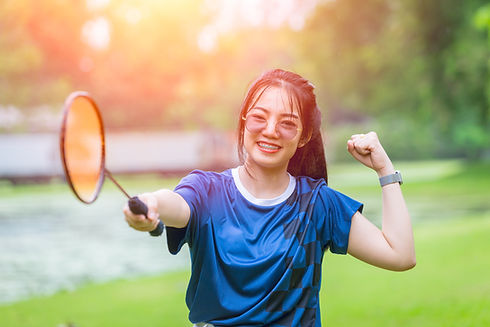 A woman holding badminton racket