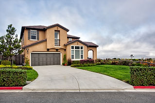 A modern detached house with a concrete driveway