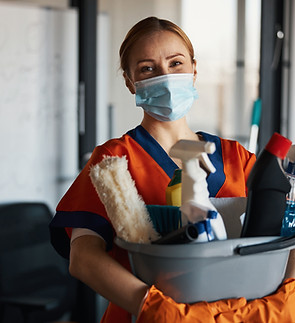 Person holding cleaning supplies