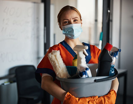 Person holding cleaning supplies