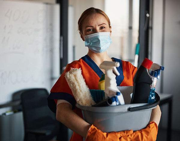 Person holding cleaning supplies