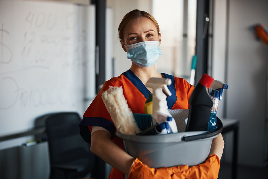 Person holding cleaning supplies