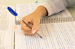 A person writing in a notebook