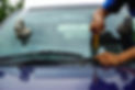Glazier using tools repairing to fix crack broken windshield on the front window glass of