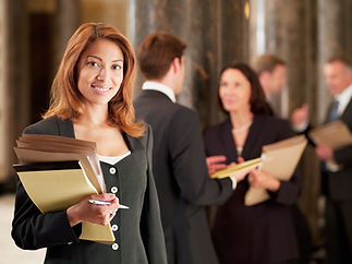Smiling lawyer holding files in corridor