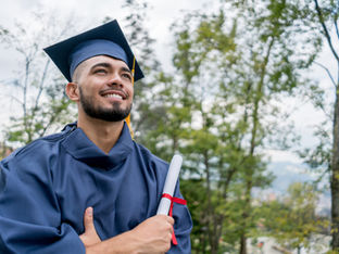 Student holding a diploma.