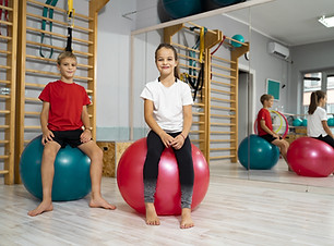 Two children on gymnastic balls