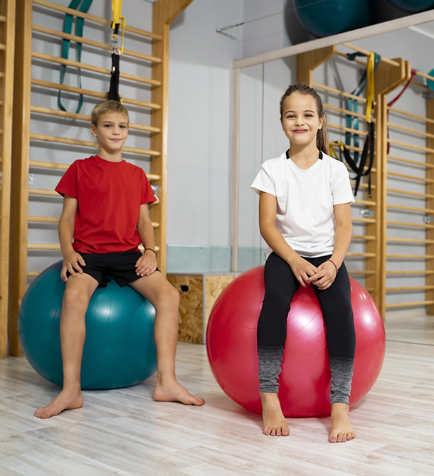 Two children on gymnastic balls