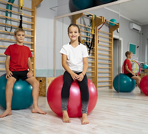 Two children on gymnastic balls