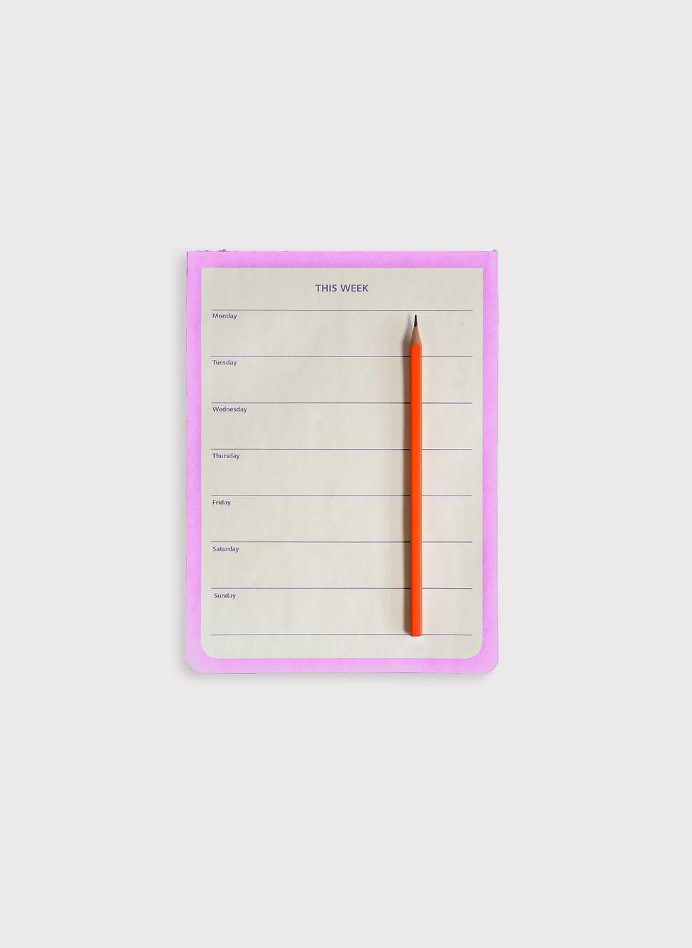 A pad with a weekly planner and a red pencil.
