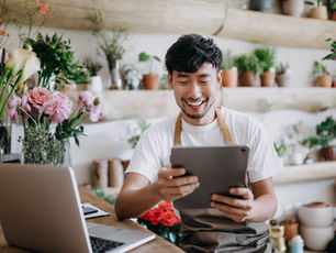 Florist shift scheduling app — florist using tablet to manage team schedule