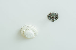 Fire sprinkler and smoke detection unit on a white ceiling