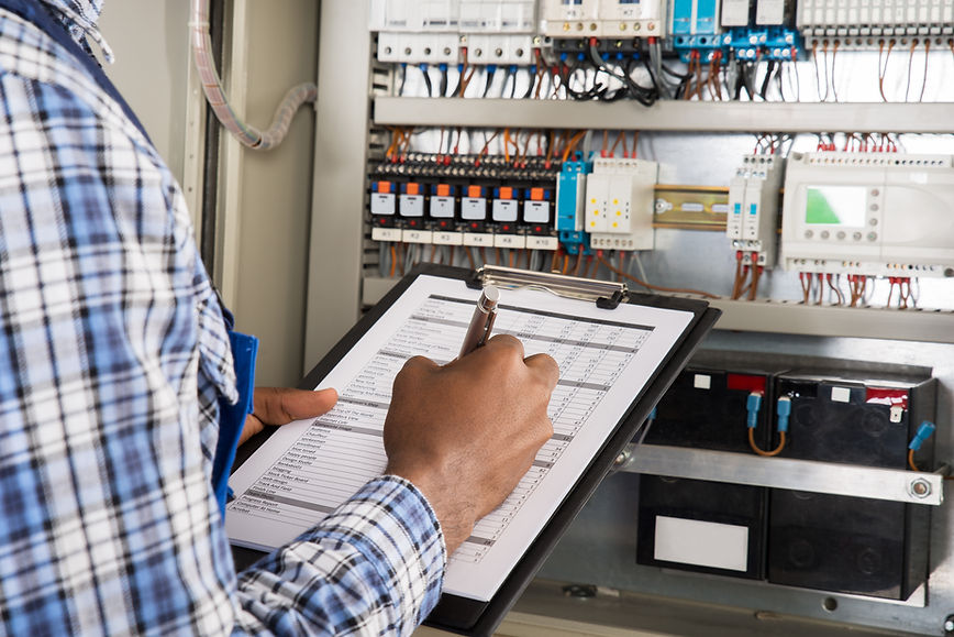 electrician's hands with clipboard