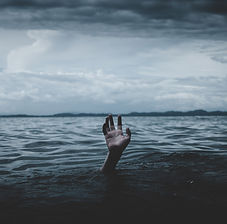 Desaturated image where a hand reaches out of the ocean. Cover for story by Davina J