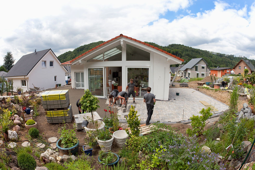 Modern single-storey home extension featuring glass doors and landscaped garden terrace