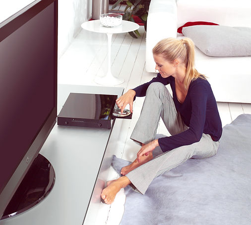 woman using dvd player in her flat