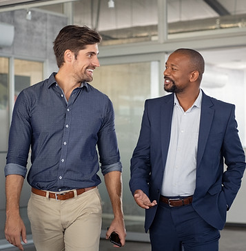Two businessmen walking while talking in English