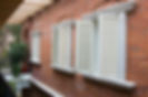 Several old style white wooden shutters in a villa