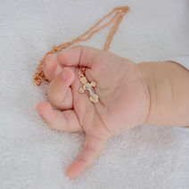 Baby Holding Cross