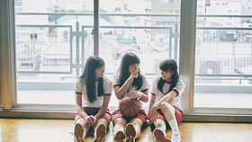 Three female students in a gym in Hong Kong
