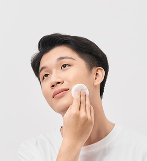 Asian man applying toner
