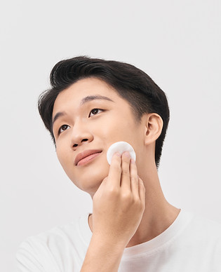 Asian man applying toner