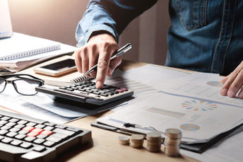 hand typing on calculator